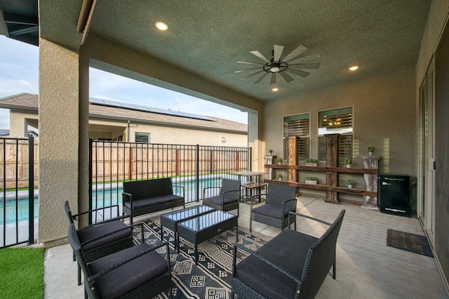 view of patio / terrace featuring an outdoor hangout area, fence, a ceiling fan, and a fenced in pool