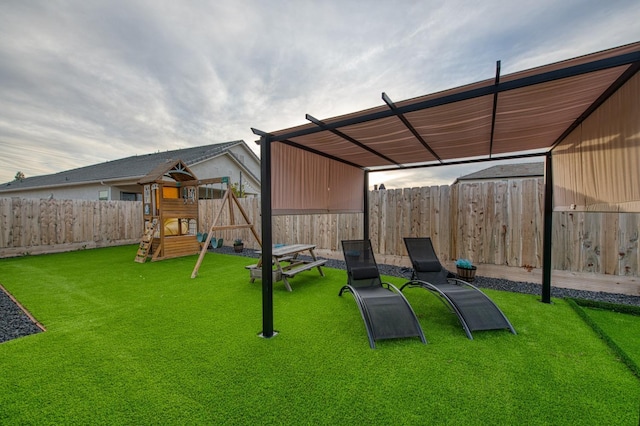 view of playground with a yard and fence