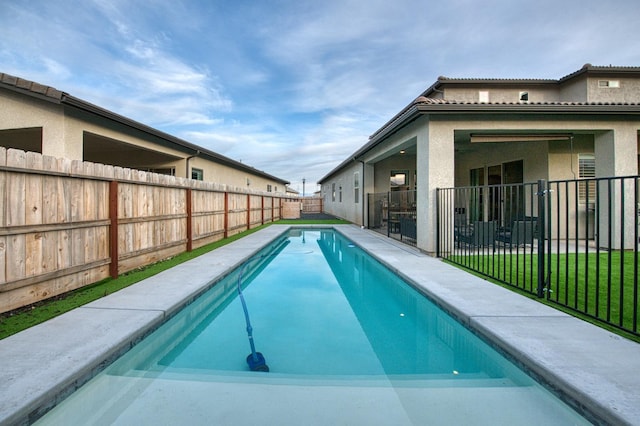 view of swimming pool with a fenced in pool and a fenced backyard