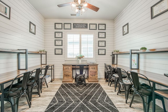 home office featuring light wood-style floors, ceiling fan, and ornamental molding