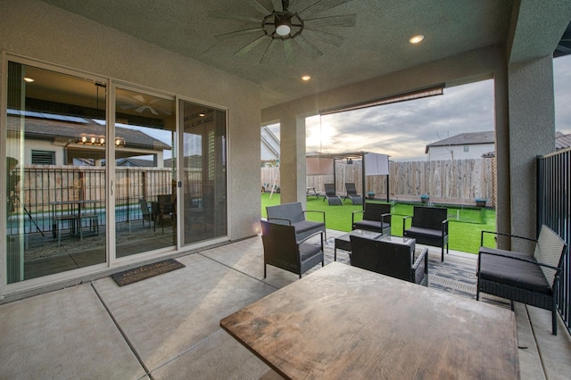 view of patio featuring a ceiling fan, outdoor lounge area, and fence