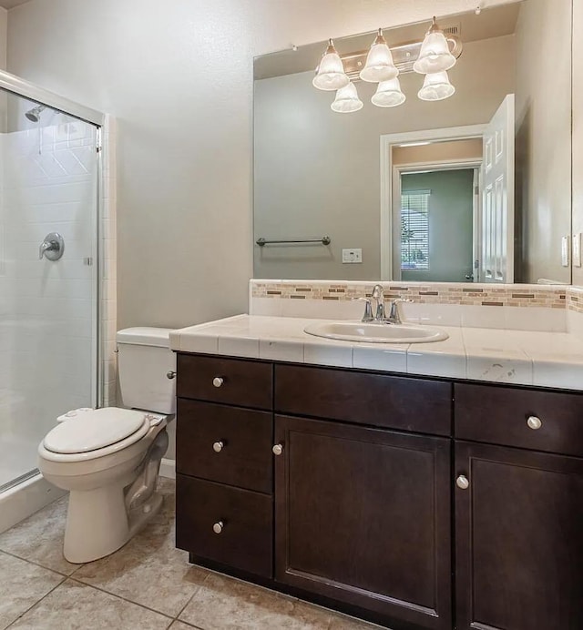 full bathroom featuring a stall shower, tile patterned flooring, vanity, and toilet