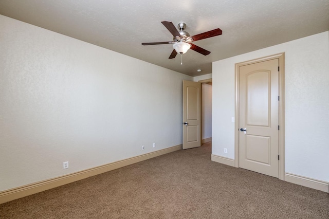 unfurnished room featuring light colored carpet, ceiling fan, and baseboards