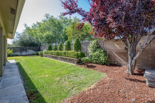 view of yard with a fenced backyard