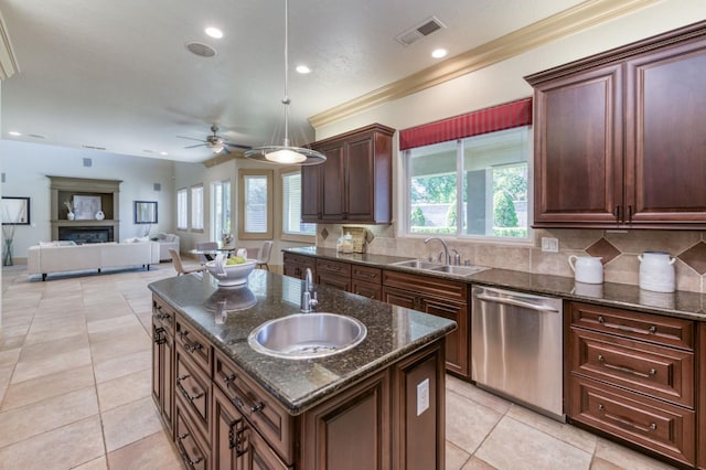 kitchen featuring dishwasher, a fireplace, a sink, and visible vents