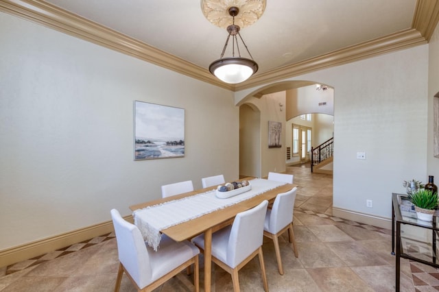 dining space with ornamental molding, arched walkways, stairway, and baseboards