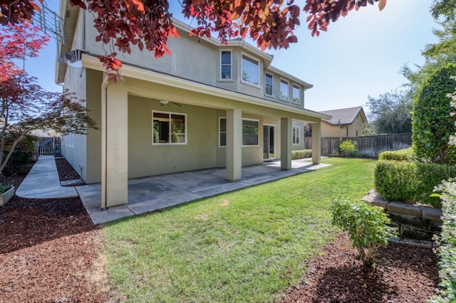 rear view of house featuring a fenced backyard, a patio, and stucco siding