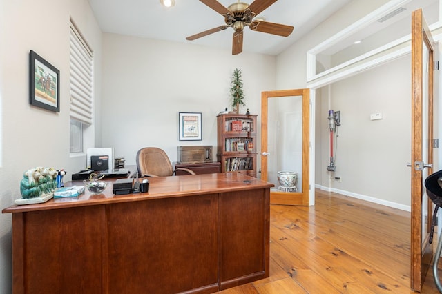 office with baseboards, ceiling fan, visible vents, and hardwood / wood-style floors