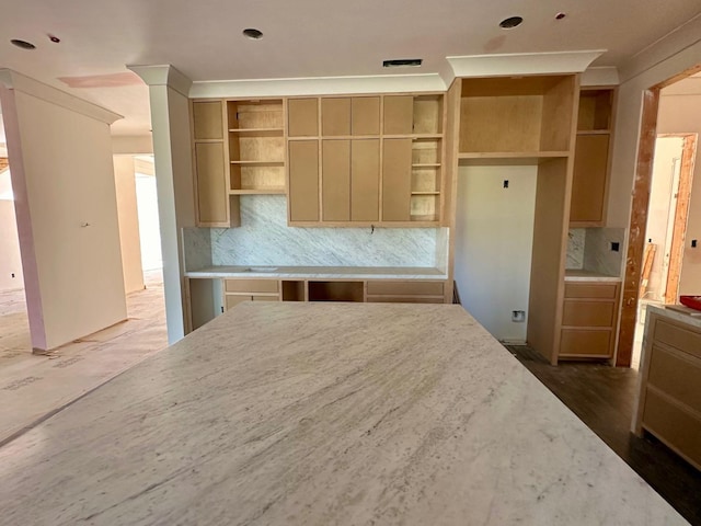 kitchen featuring tasteful backsplash, light stone counters, and open shelves
