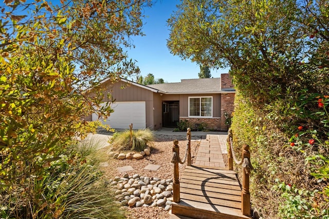 ranch-style house with an attached garage and brick siding