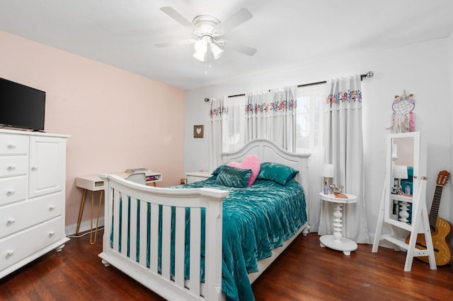 bedroom with ceiling fan, baseboards, and wood finished floors