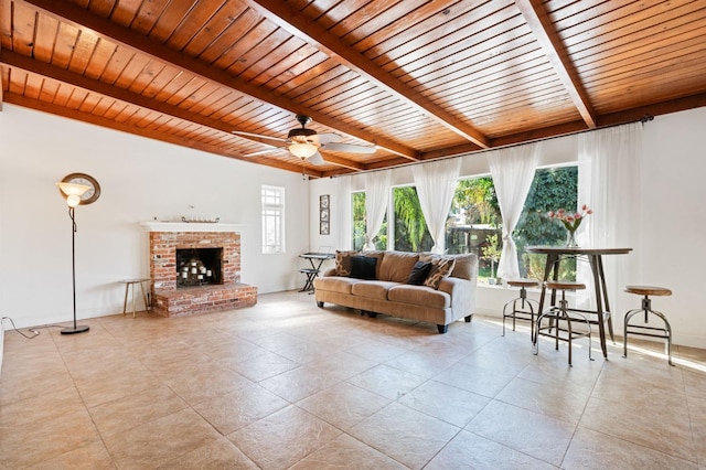 tiled living room featuring a ceiling fan, wood ceiling, beam ceiling, and a fireplace