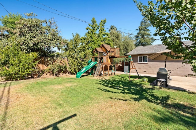 view of yard featuring fence and a playground