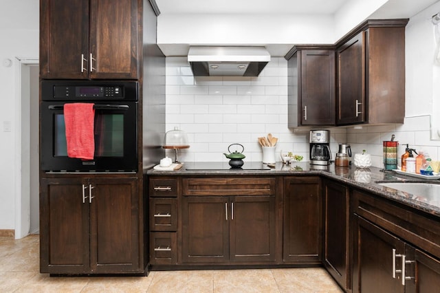 kitchen with black appliances, tasteful backsplash, extractor fan, and dark brown cabinets