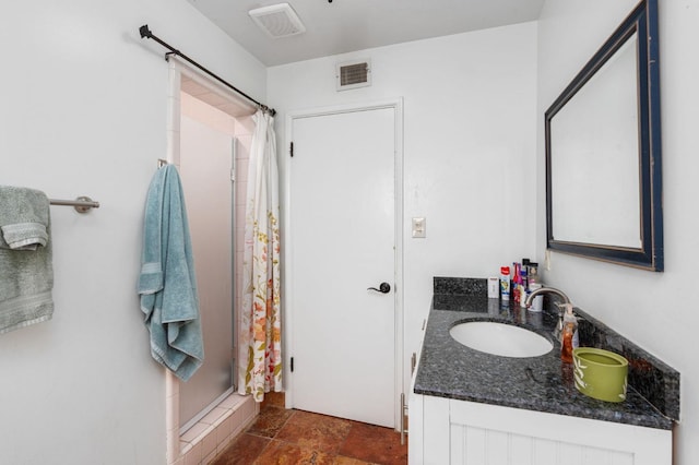 full bathroom with visible vents, stone finish flooring, a shower stall, and vanity