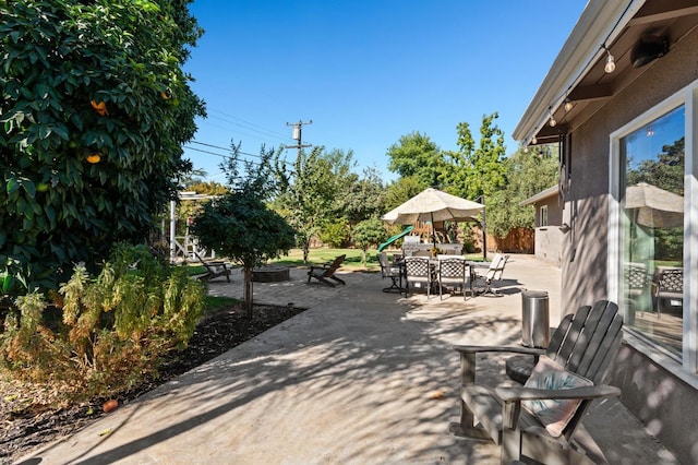 view of patio with an outdoor fire pit and outdoor dining area