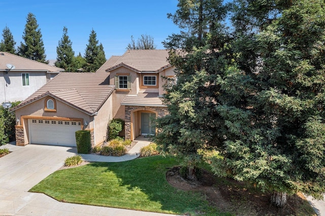 view of front of home with an attached garage, stone siding, concrete driveway, a tiled roof, and a front yard