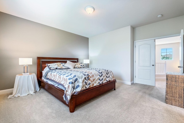 bedroom featuring carpet and baseboards