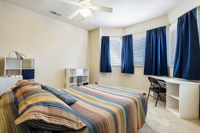 bedroom with carpet floors, baseboards, visible vents, and ceiling fan