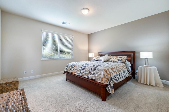 bedroom with carpet floors, visible vents, and baseboards