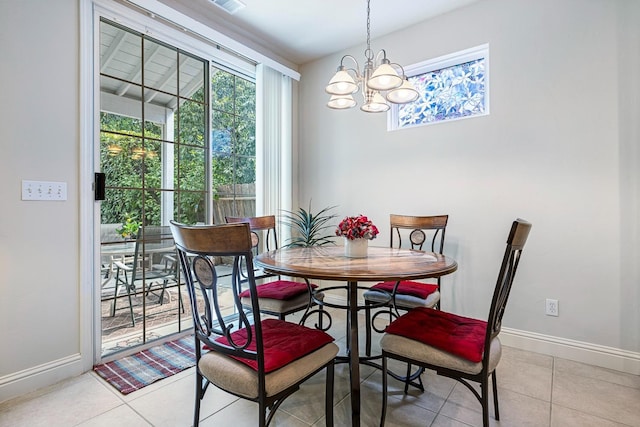 dining space featuring light tile patterned floors, visible vents, baseboards, and a chandelier