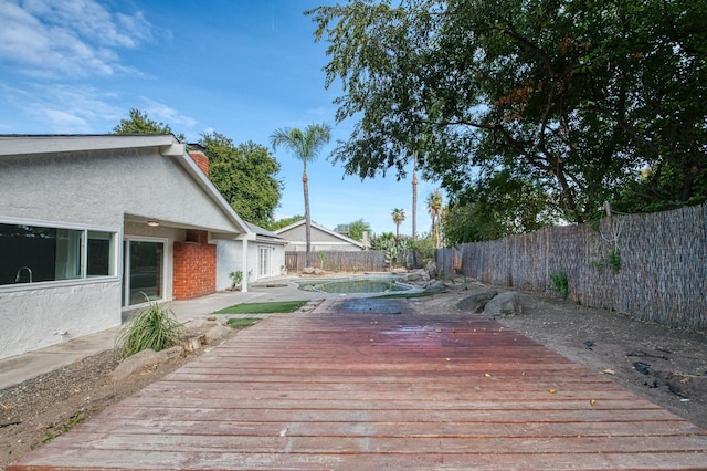 deck with a fenced in pool and a fenced backyard