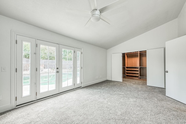 unfurnished bedroom featuring lofted ceiling, ceiling fan, access to outside, carpet flooring, and french doors