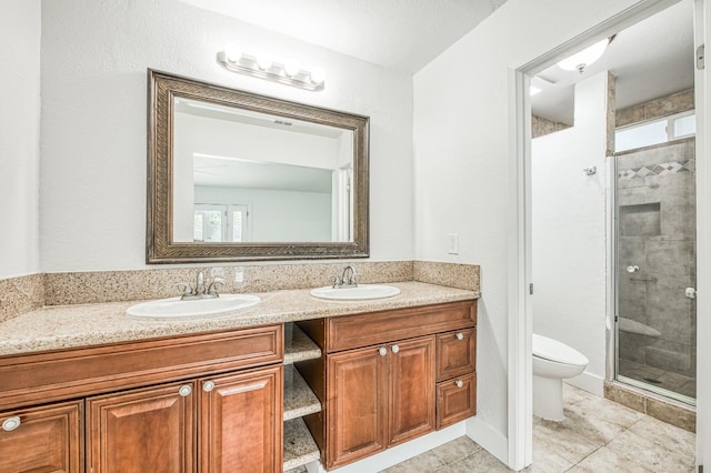 full bathroom featuring a stall shower, a sink, toilet, and double vanity