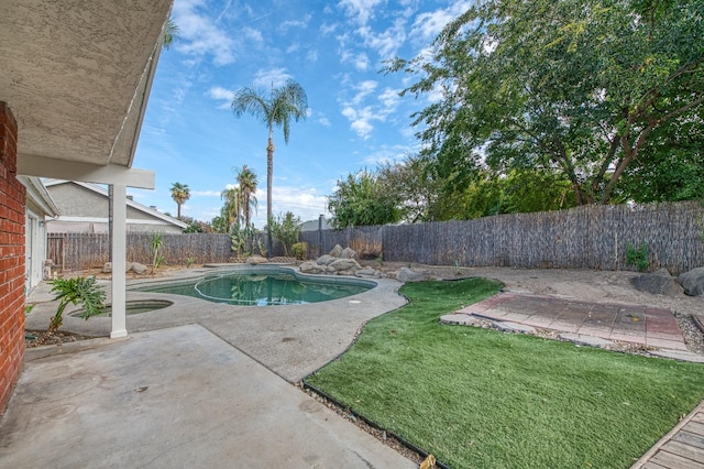 view of swimming pool featuring a patio, a lawn, a fenced backyard, and a fenced in pool