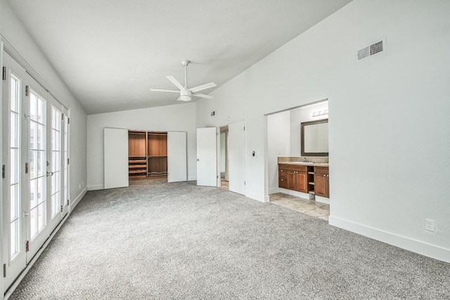 unfurnished bedroom featuring light carpet, a closet, visible vents, and baseboards