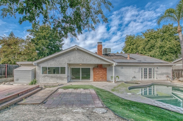 back of house with stucco siding, a patio area, fence, and french doors