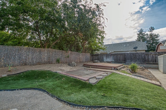 view of yard featuring a fenced backyard and a wooden deck