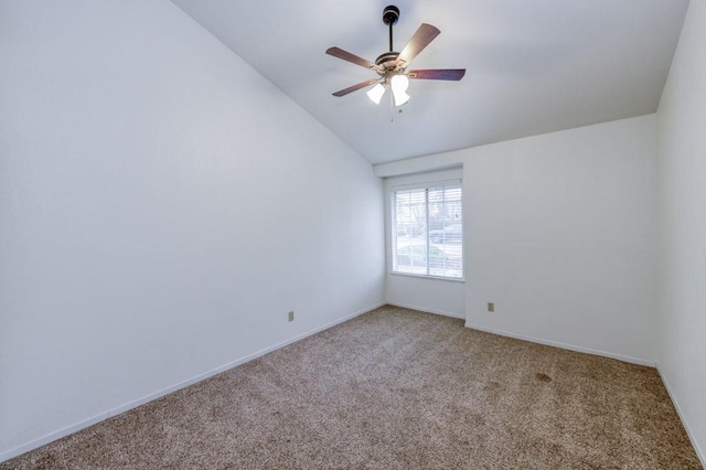 unfurnished room featuring lofted ceiling, ceiling fan, carpet flooring, and baseboards