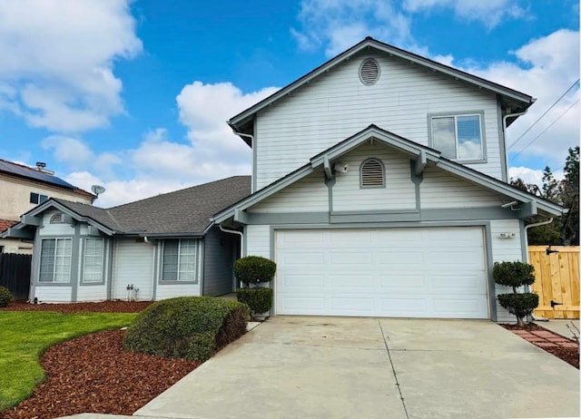 traditional-style house with driveway and fence