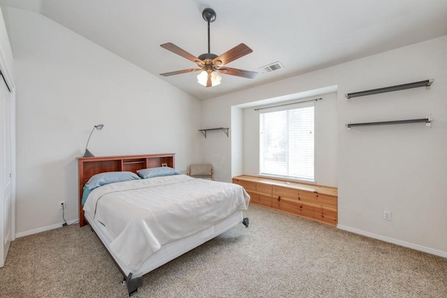 carpeted bedroom featuring lofted ceiling, visible vents, ceiling fan, and baseboards