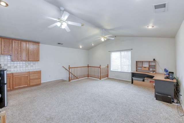 home office with lofted ceiling, visible vents, light carpet, and baseboards