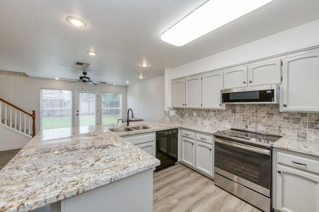 kitchen featuring tasteful backsplash, visible vents, stainless steel appliances, and a sink