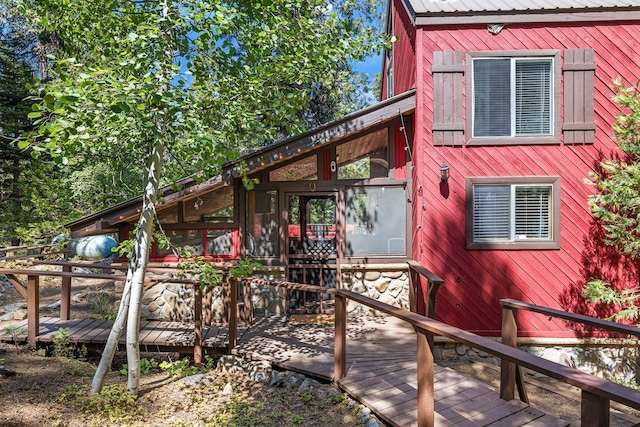 exterior space featuring metal roof and a deck