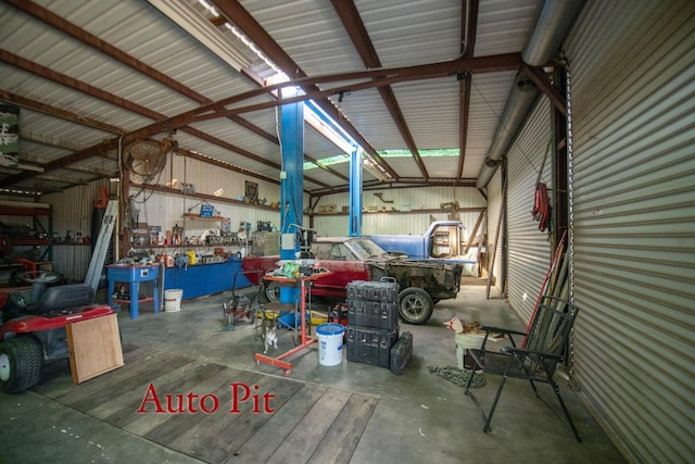 garage featuring metal wall and a workshop area