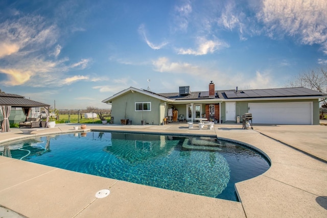 pool featuring a patio area, fence, a gazebo, and central AC unit