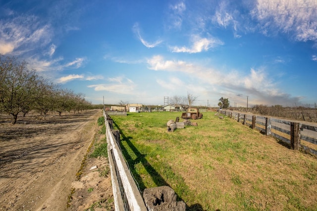 view of yard featuring a rural view and fence