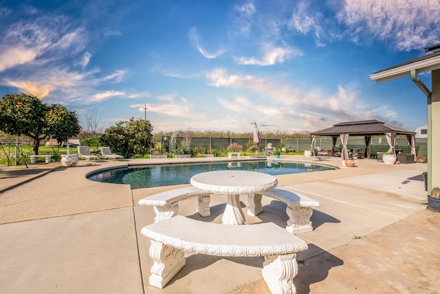 view of swimming pool with a fenced in pool, fence, a patio, and a gazebo