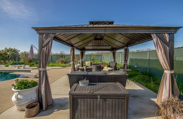 view of patio / terrace with an outdoor pool, fence, an outdoor living space, and a gazebo