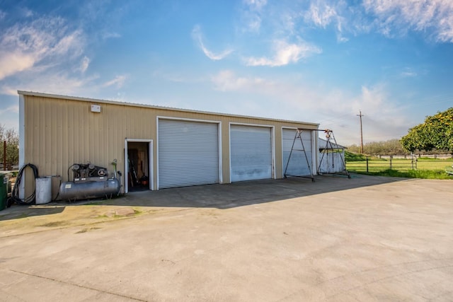 detached garage featuring fence