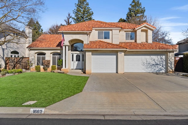 mediterranean / spanish house featuring driveway, a garage, stucco siding, a tiled roof, and a front yard