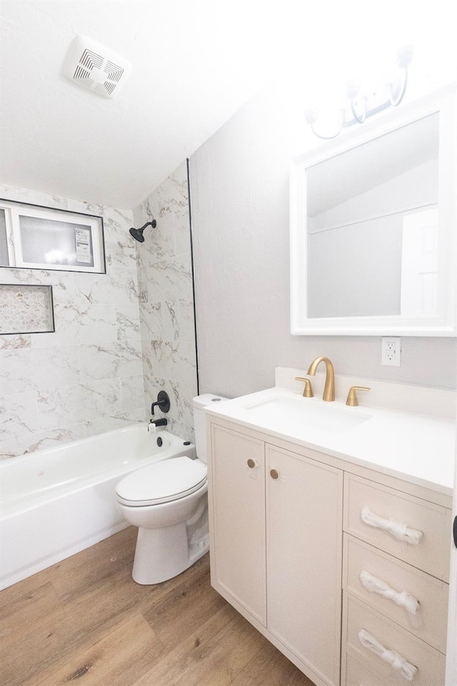 full bath with shower / washtub combination, visible vents, toilet, vanity, and wood finished floors