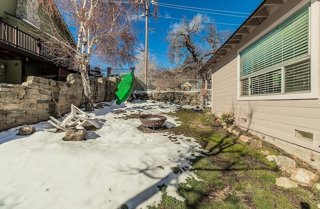 view of patio / terrace featuring fence and a fire pit