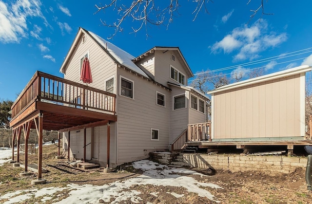 back of property with a wooden deck