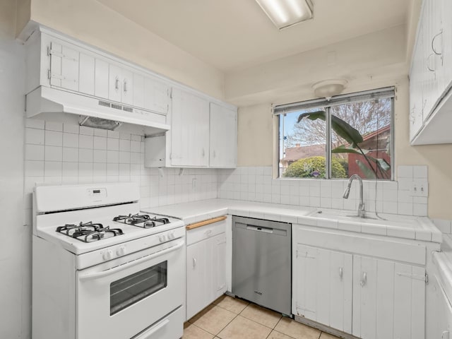 2103 N Price Ave Unit 106, Fresno, CA 93703 - kitchen featuring gas range gas stove, dishwasher, under cabinet range hood, tile counters, and a sink