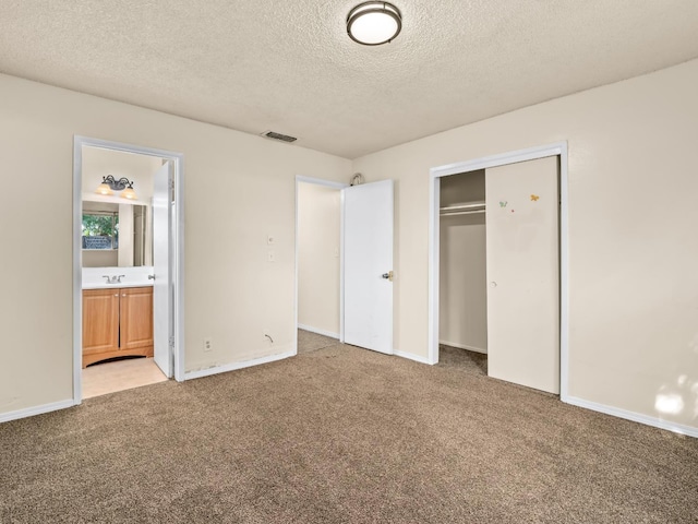 2103 N Price Ave Unit 106, Fresno, CA 93703 - unfurnished bedroom featuring light colored carpet, a textured ceiling, a closet, a sink, and baseboards